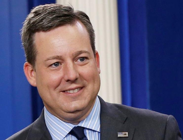 Ed Henry smiling in black suit